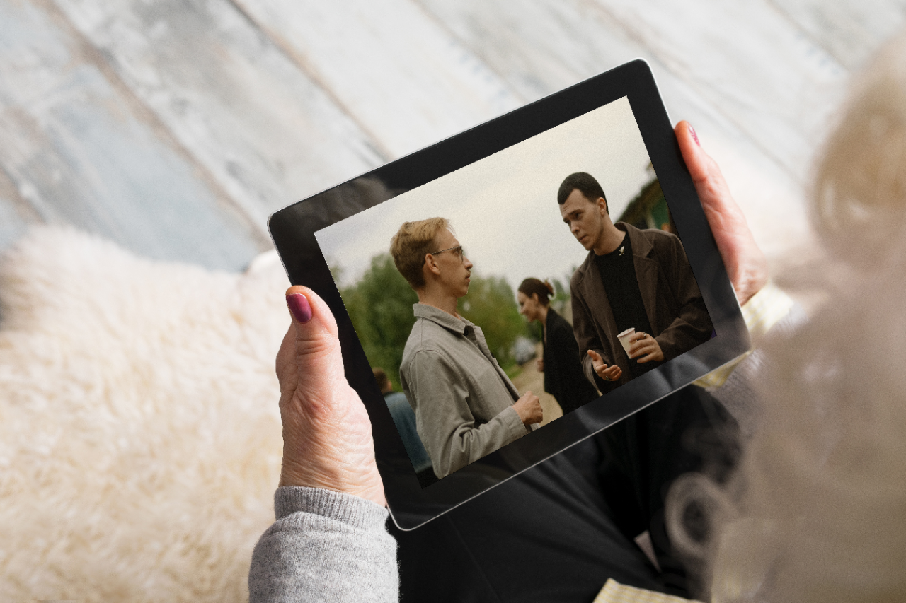 Senior holding blank screen tablet